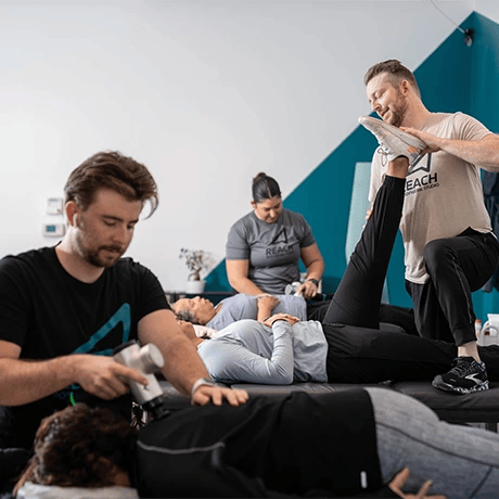 people stretching together at Reach Bodywork Studio